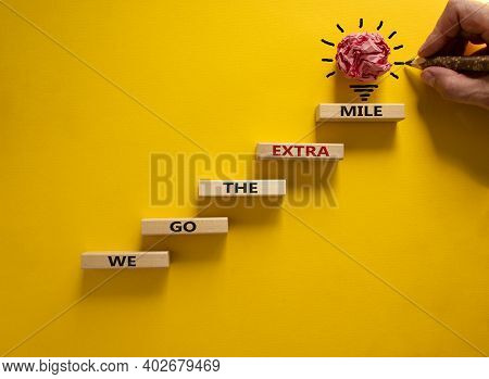 We Go The Extra Mile Symbol. Wood Blocks Stacking As Step Stair On Beautiful Yellow Background, Copy