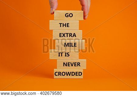 Go The Extra Mile Symbol. Wooden Blocks With Words 'go The Extra Mile It Is Never Crowded'. Male Han