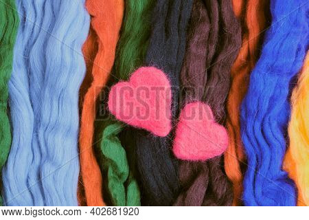 Two Woolen Hearts On A Background From Woolen Felting In The Form Of Lines. Top View Close Up