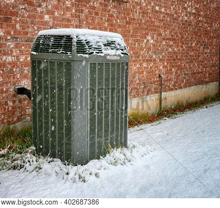 Modern High Efficiency Air Conditioner Under Falling Snow