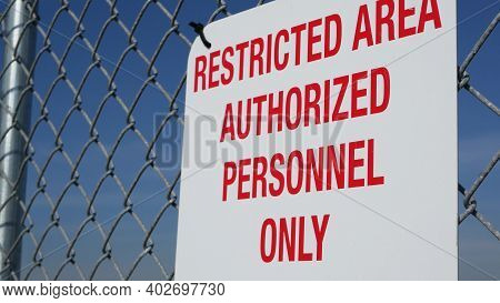 Restricted Area, Authorized Personnel Only Sign In Usa. Red Letters, Keep Off Warning On Metal Fence