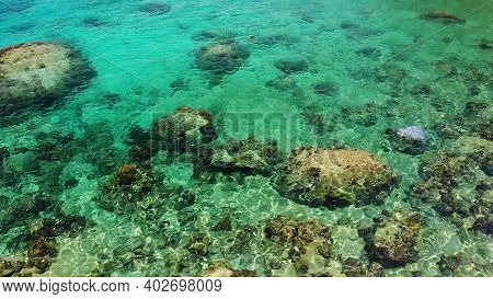 Calm Sea Water Near Stones. Peaceful Blue Sea Water And Gray Boulders In Perfect Place For Snorkelin