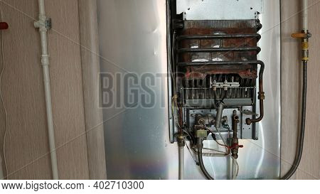 Old Gas Boiler Without Protective Cover With Visible System Structure And Scorched Base Metal, Home 