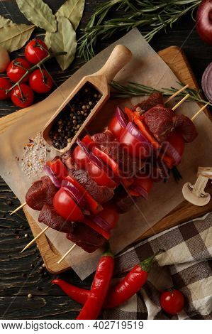 Concept Of Cooking Barbecue With Raw Shish Kebab And Ingredients On Wooden Background