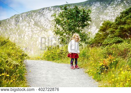 Cute Little Happy Toddler Girl Running On Nature Path In Glenveagh National Park In Ireland. Smiling