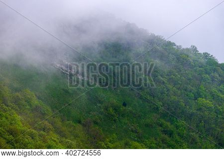 Majestic View On Beautiful Fog Mountains In Mist Landscape. Dramatic Unusual Scene. Travel Backgroun