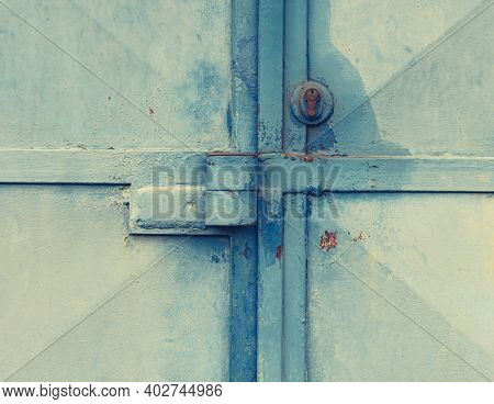 Garage Entry Locked With Theft Resistance Locking Latch And Locking Security Insert. Cracked Painted