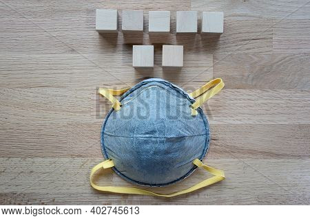 N95 Mask On The Wooden Table With Group Of Wooden Cube For Input Wording,helps Prevent Corona Virus 