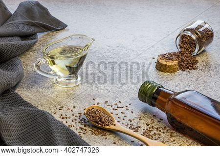 Linseed Oil In Glass Gravy Boat And Bottle, Flaxseed In Wooden Spoon And Jar, Vegetable Source Of Om