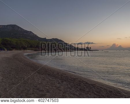 Early Morning Sunrise View Of Sand Beach Spiaggia Di Santa Maria Navarrese, Sea With Green Forest An