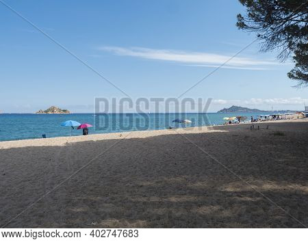 View Of Sand Beach Spiaggia Di Santa Maria Navarrese, Sea With Colorful Beach Umbrella And Sunbeds A