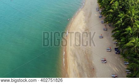 Blue Lagoon And Sandy Beach With Palms. Aerial View Of Blue Lagoon And Sun Beds On Sandy Beach With 