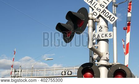 Level Crossing Warning Signal In Usa. Crossbuck Notice And Red Traffic Light On Rail Road Intersecti