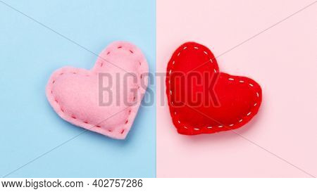 Valentines day greeting card. Heart shaped decor over blue and pink background. Top view flat lay