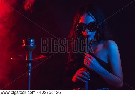 Hookah Atmosphere. The Girl Enjoys Smoking A Hookah, Sheesha. Surrealism