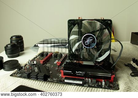 Moscow, Russia - 5 December 2020: Pc Msi Motherboard With Cpu Fan And Ram Memory Bars. Assembling Th