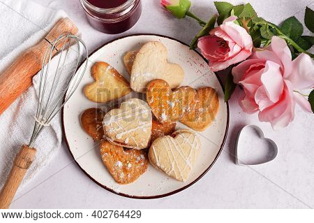 Baked Cookies-hearts On The Kitchen Table With Pink Flowers Roses