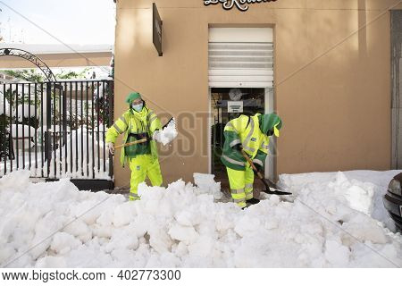 Madrid, Spain - January 10, 2021: Woman Worker From The Municipal Cleaning Service Work Cleaning The