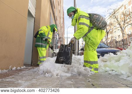 Madrid, Spain - January 10, 2021: Women Workers From The Municipal Cleaning Service Work Cleaning Th