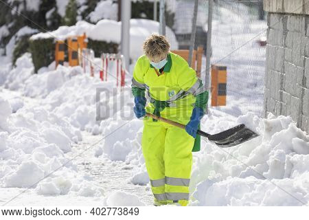 Madrid, Spain - January 10, 2021: Woman Worker From The Municipal Cleaning Service Work Cleaning The