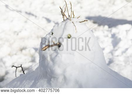 Madrid, Spain - January 10, 2021: A Snowman Melting In The Middle Of Narvaez Street, On A Snowy Day,