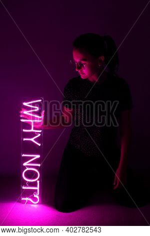 Beautiful Young Girl Holding Pink Neon Sign Why Not?. Trendy Style. Neon Sign. Custom Neon. Home Dec