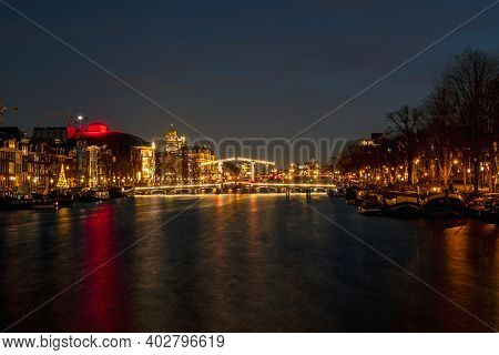 Tiny bridge in Amsterdam the Netherlands at sunset at the Amstel