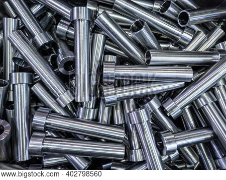 Pile Of Shiny Steel Tubes After Cnc Turning Operations - Abstract Full Frame Indistrial Background