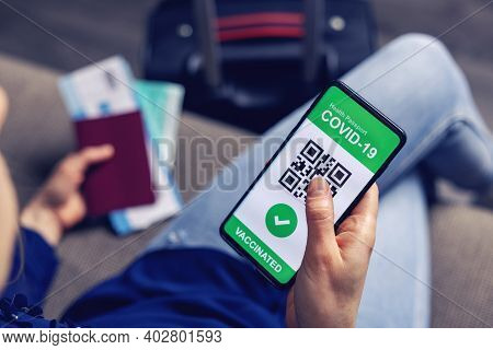 Vaccinated Person Using Digital Health Passport App In Mobile Phone For Travel During Covid-19 Pande