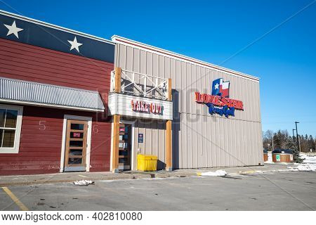 Ottawa, Ontario, Canada - January 8, 2021: The Take Out Entrance At A Lone Star Texas Grill Tex-mex 