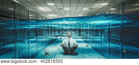 smiling man sitting on the floor of a flooded server center.
