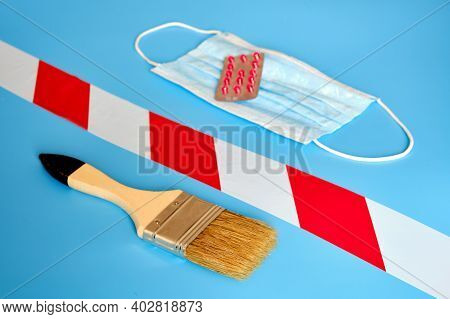 Paint Brush, Stop Tape, Pills And Medical Mask On A Blue Background, Close-up. Concept Of Problems W
