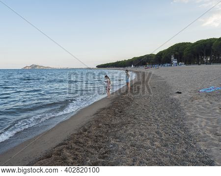 Santa Maria Navarrese, Sardinia, Italy, September 6, 2020: Two Young Woman Standing On The Sand Beac