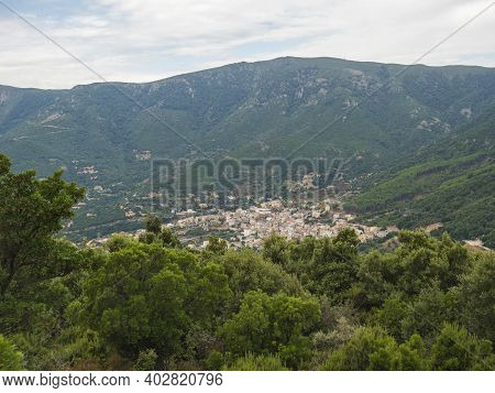 Aerial View Of Green Landscape Of Supramonte Mountains With Urzulei Town, Limestone Rock And Mediter