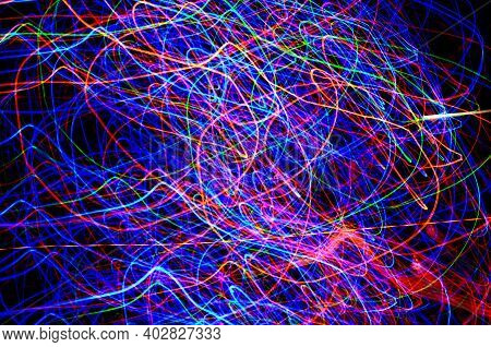 Abstract Tangled Lines On A Black Background Represent The Movements Of Electrons In Their Cosmic Or
