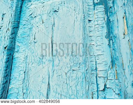 Close-up Old Blue Cracked Paint. The Texture Of The Old Emerald Paint With Cracks. Dried In The Sun 