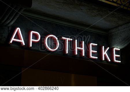 Luminous Apotheke (english Translation Of Drugstore) Neon Inscription Hanging On A Pharmacy Store In