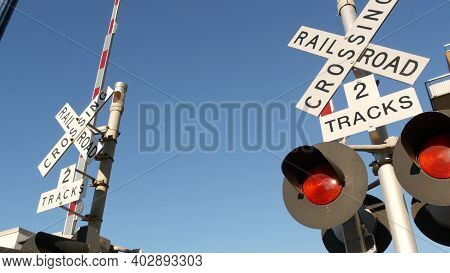 Level Crossing Warning Signal In Usa. Crossbuck Notice And Red Traffic Light On Rail Road Intersecti
