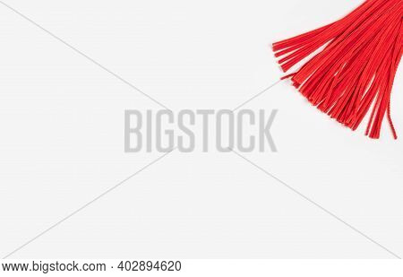 Red Chenille Wire On A Light Background. A Lot Of Material For Needlework. Place For Text.