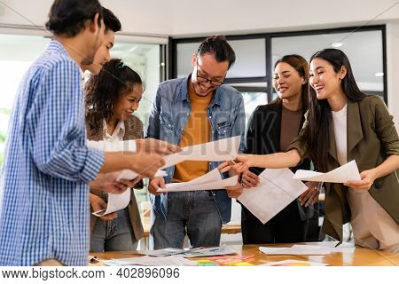 Interracial asian business team brainstorming idea talk and discuss at office meeting room after reopen due to coronavirus COVID-19 city lockdown. Business startup meeting and brainstorm concept.