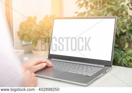 Hand Typing Mockup Laptop Computer Showing Blank White Screen On Table Office Place. Blank Screen La