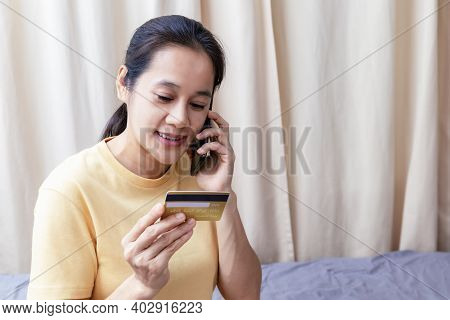 Happy Asian Women Use Smart Phone And Creadit Card Speak To Pay Shopping Online. Women Use Smartphon