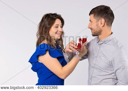 Young Couple Inlove Celebrating St.valentines Day With Glasses Of Wine, Drinking At Bruderschaft.