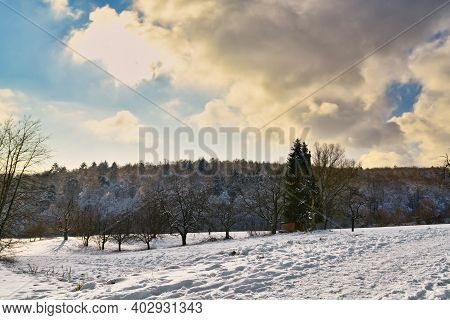 Snow Covered Winter Landscape In German Odenwald Forest With Golden Backlight Sunlight