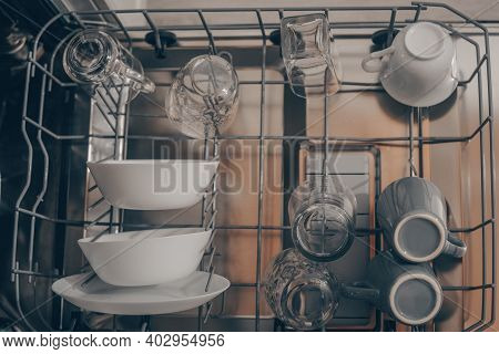 Built-in Dishwasher In The Kitchen, Washing Dishes. Plates, Cups, Glasses Are Worth Washing. Househo