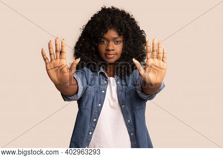 Irritated Young Black Woman Showing Stop Gesture With Both Palms Over Grey Studio Background, Copy S