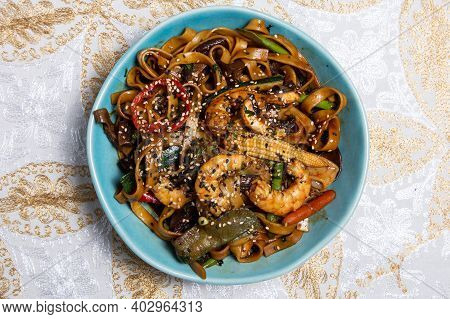 Buckwheat Stir-fry Noodles With Seafood - Shrimps, Octopus, Squid In Cast Iron Asian Wok With Cookin