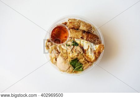 Delicious Vietnamese Bo Bun prepared with rice vermicelli noodles for basics and for topping chicken pieces and fried spring rolls