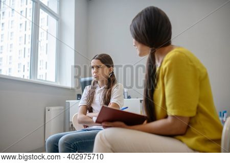 Silent Sad Girl And Woman With Notepad
