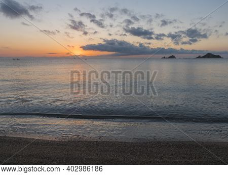 Sunrise With The Red Orange Sun Raising Up From The Sea With Dark Clouds At Beach Spiaggia Di Santa 